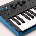 Modal Electronics Element One keyboard synthesizer with a sleek black design and control knobs on a music studio setup.