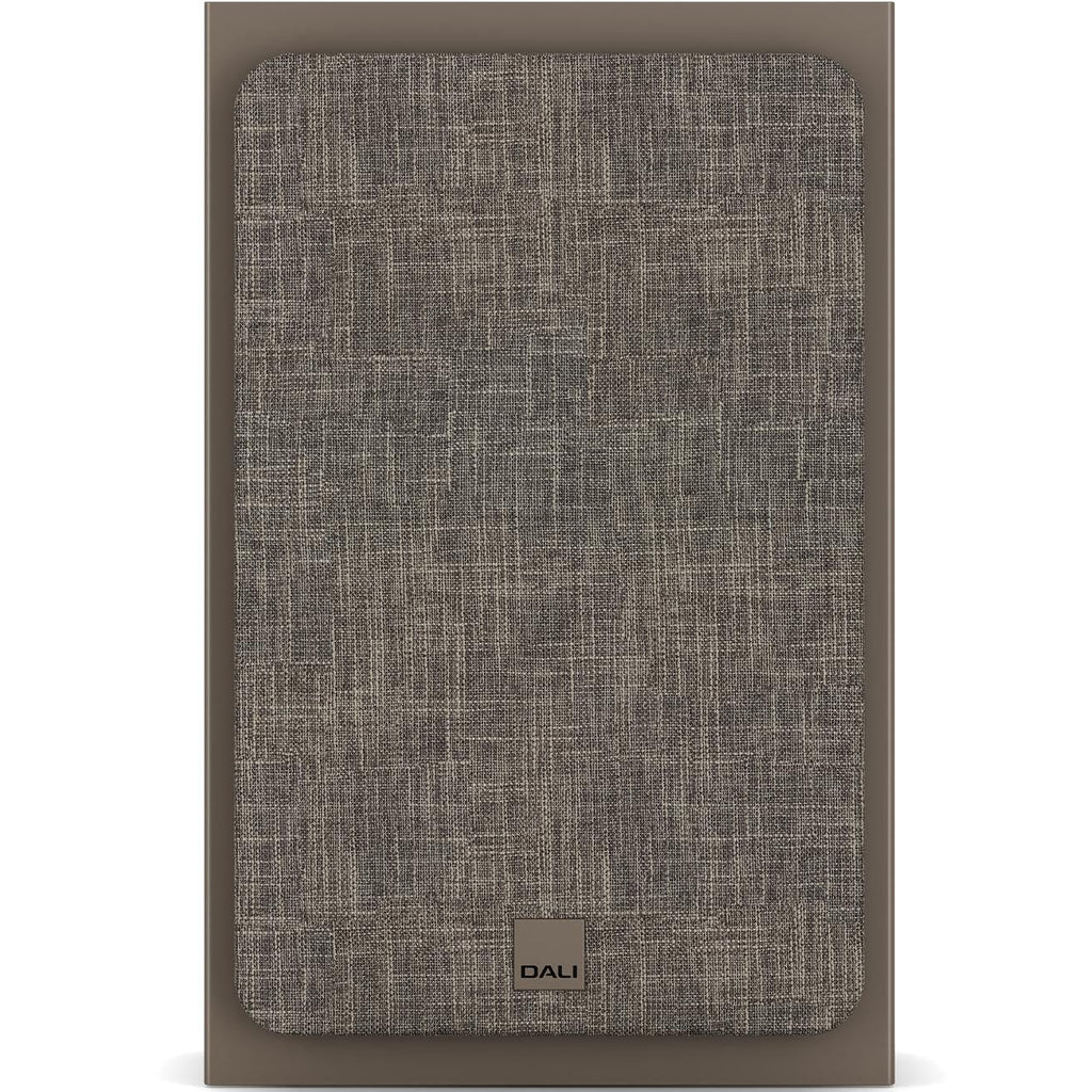DALI Sonik On-Wall in-wall speaker installed on a wall, designed for outdoor and indoor audio, with sleek black grille and slim profile.