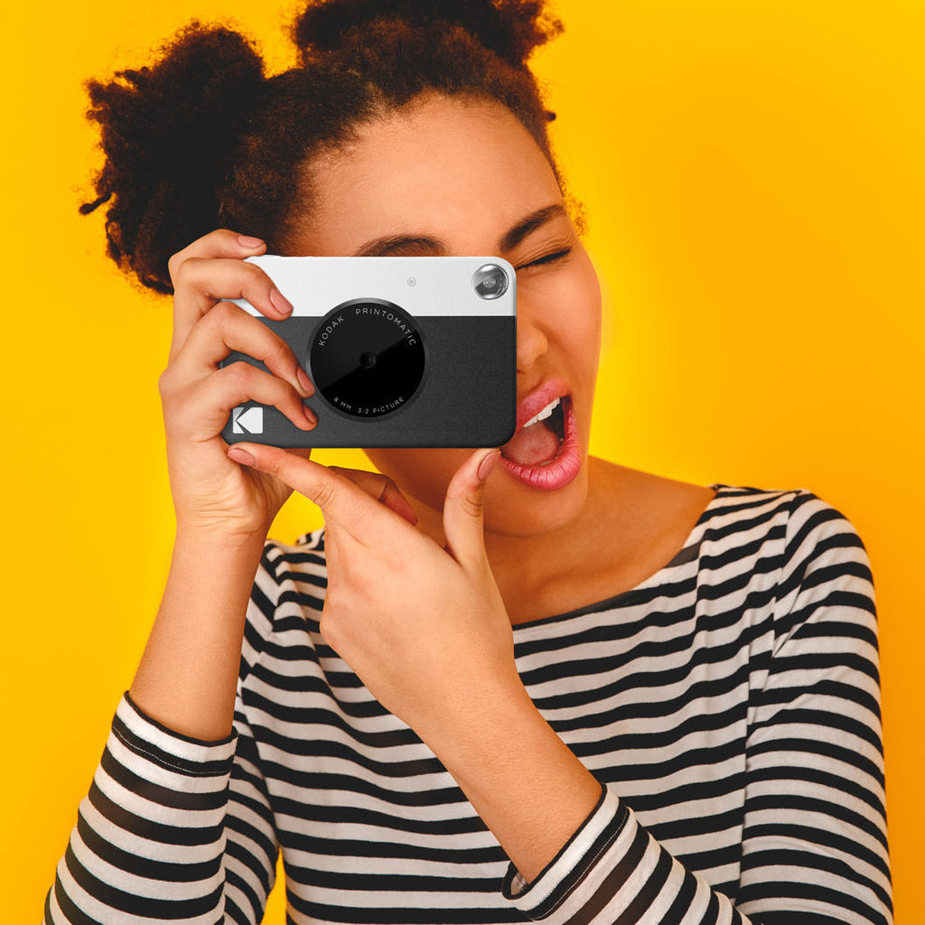 Kodak Printomatic instant compact camera with colorful design and lens, ready for quick photo printing and sharing.