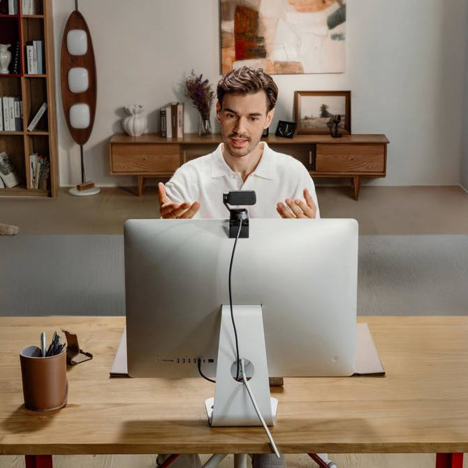 Insta360 Link 2 Pro video conferencing camera with adjustable lens and built-in microphone for clear online meetings.