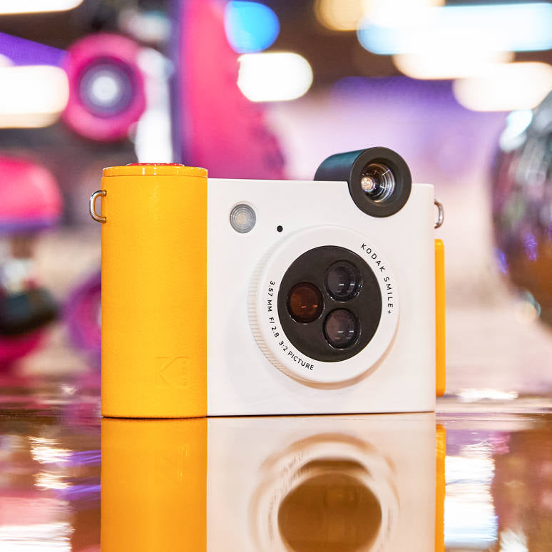 Kodak Smile+ instant compact camera with colorful design and lens, ready for instant photo printing.