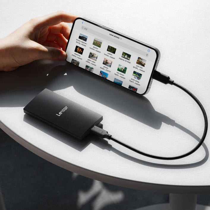 Lexar SL300 Portable SSD external drive shown with sleek black design and USB connection port.