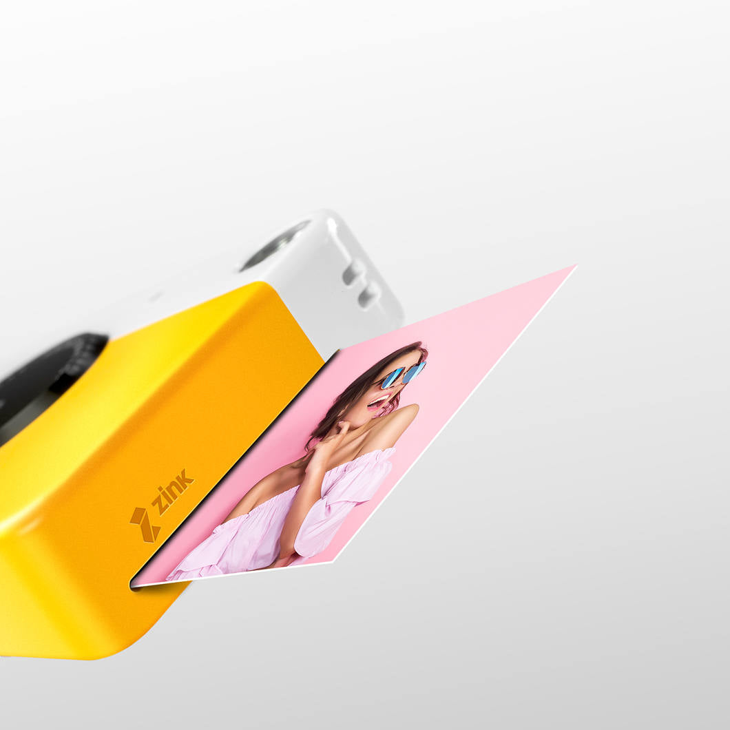 Kodak Printomatic instant compact camera with black body and lens, ready for quick photo printing and sharing.