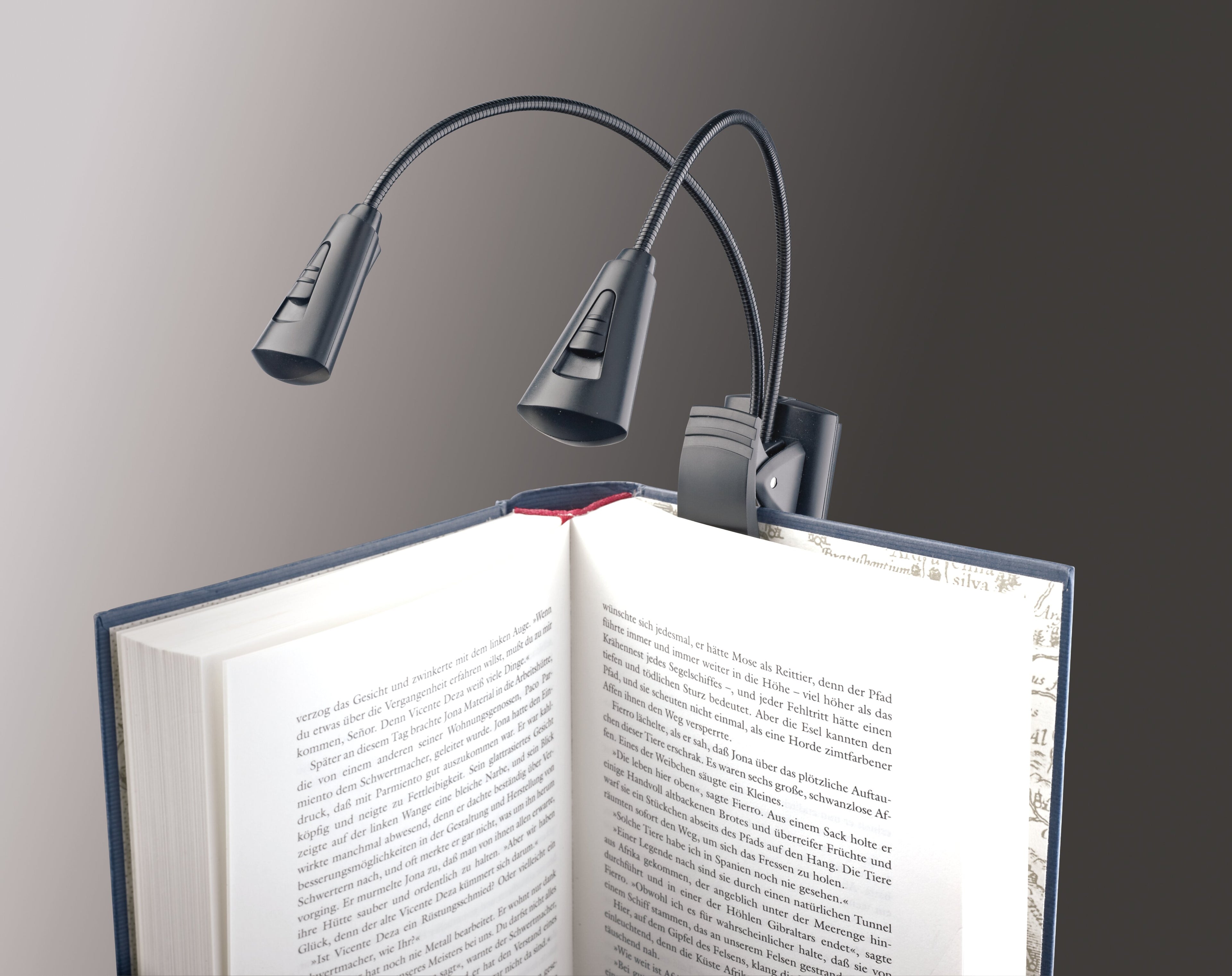 K&M 12244 music stand light attached to a black adjustable stand, providing focused illumination for sheet music.