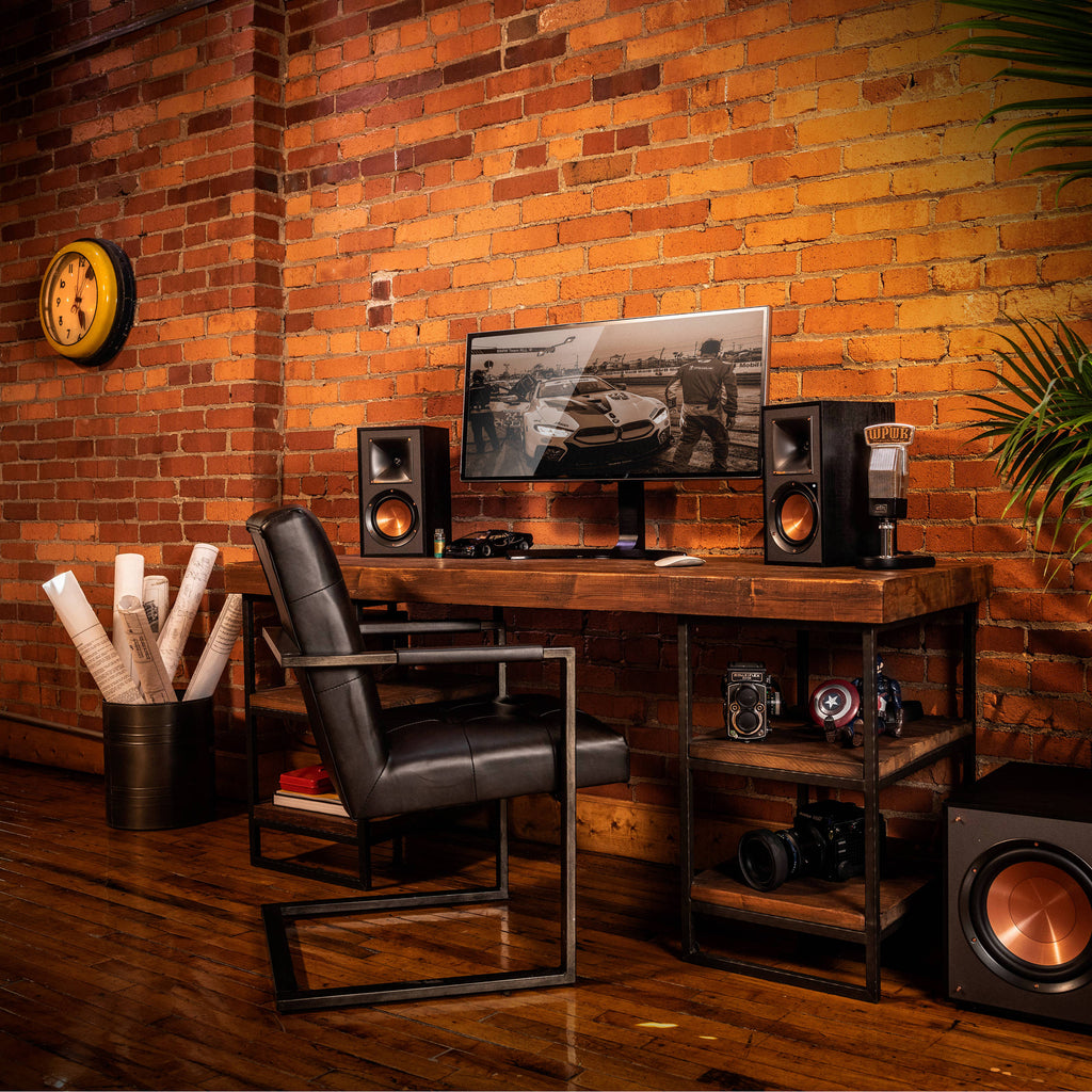 Klipsch R-51PM active bookshelf speakers with black cabinets and front-facing control knobs, designed for high-quality audio.
