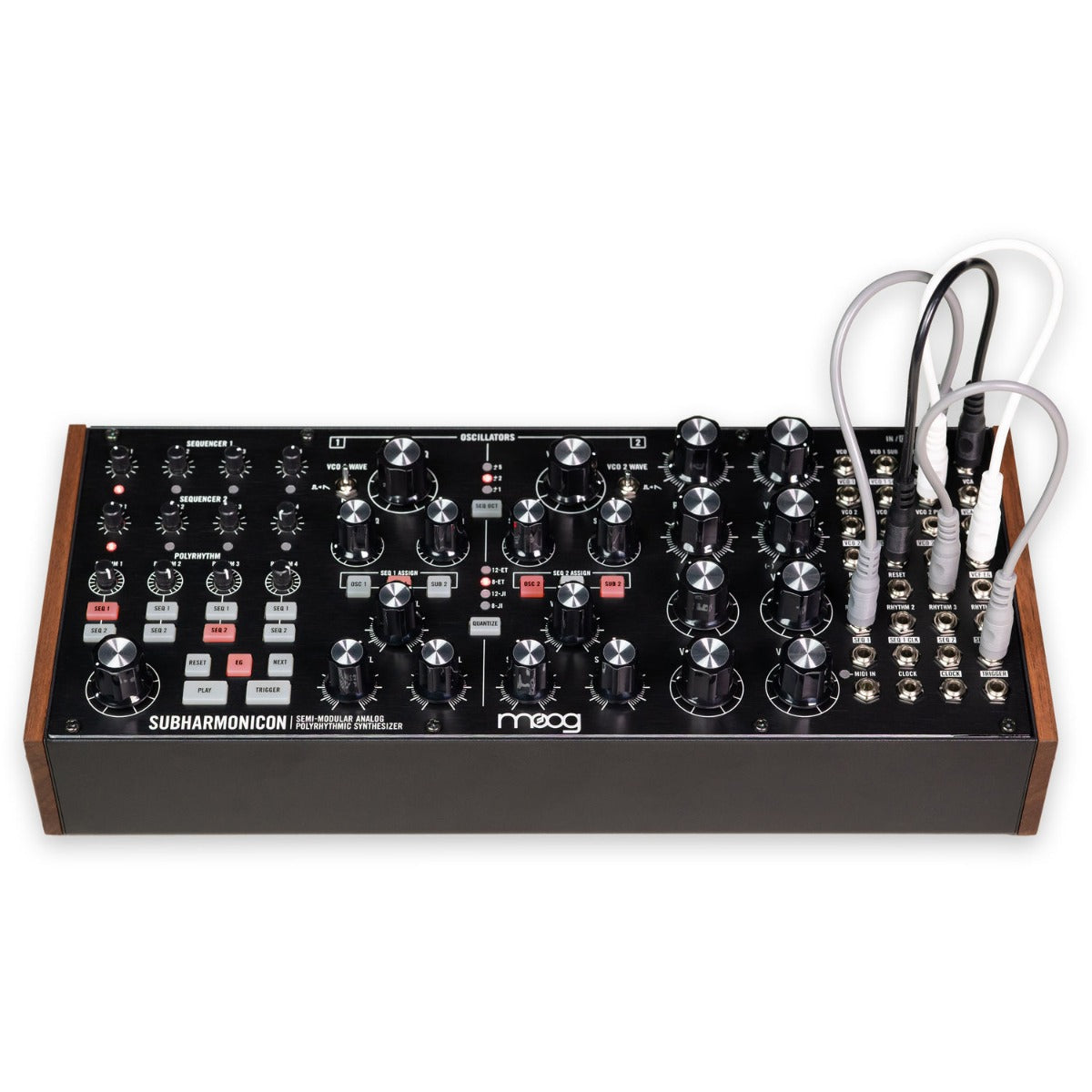 Moog Subharmonicon synthesizer with patch cables and control knobs on a wooden surface.