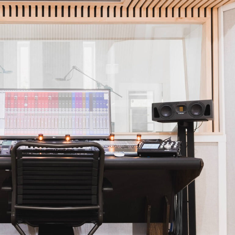 Adam Audio A44H mid-field and main monitors shown on a studio desk with clean white background.