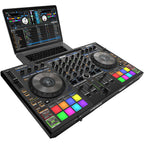 Reloop Mixon 8 Pro DJ controller with sleek design, jog wheels, and multiple input/output ports displayed on a table.