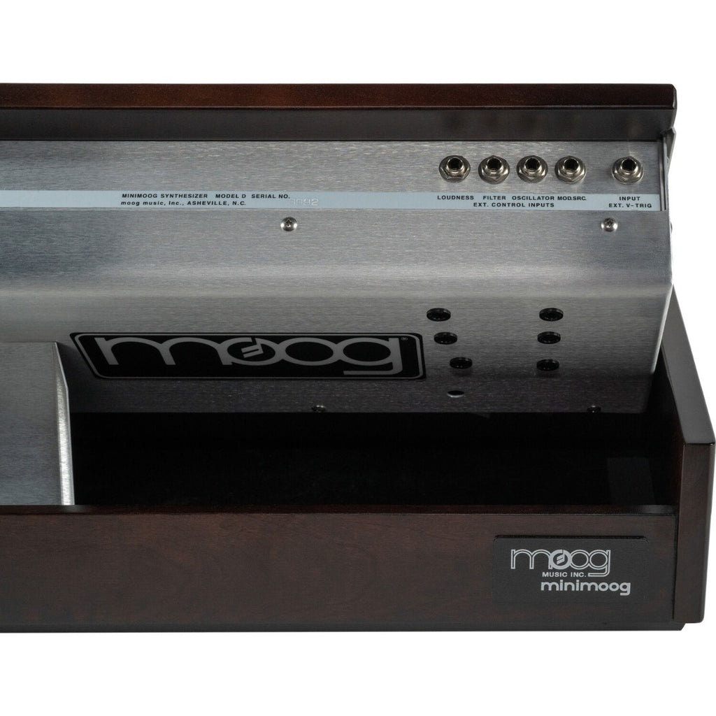 Moog Minimoog Model D synthesizer with black control panel and vintage-style knobs, set on a wooden stand.