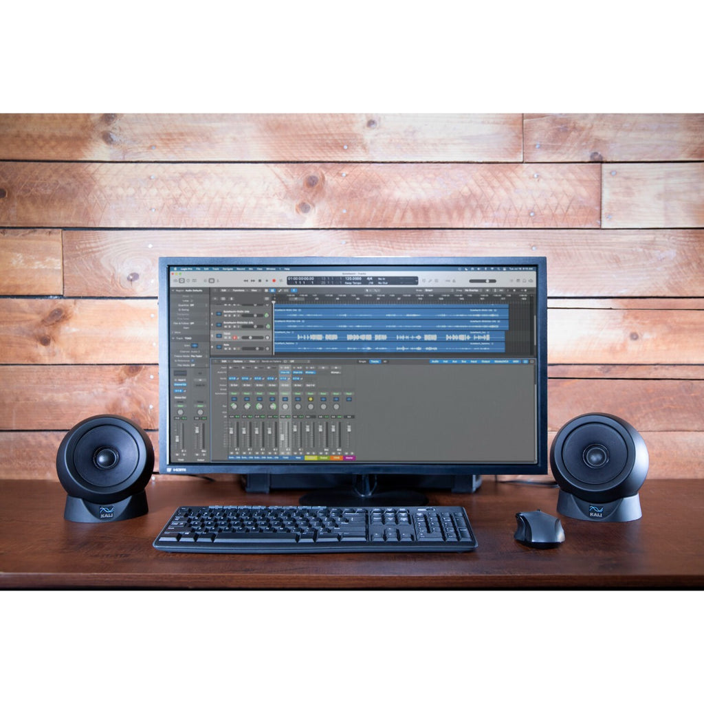 Pair of Kali Audio IN-UNF studio monitors with subwoofer in a professional recording studio setup.