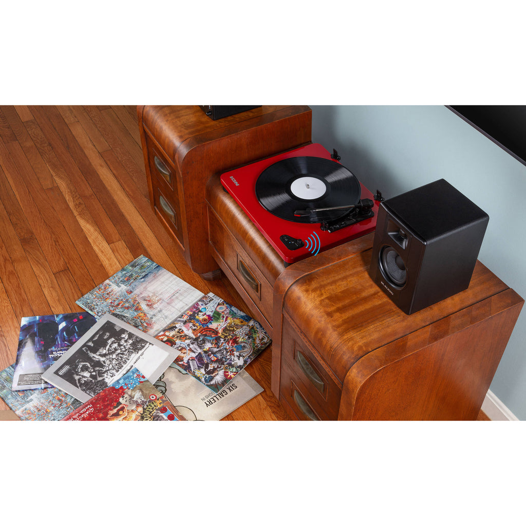 M-Audio BX3 BT desktop speakers shown on a desk with cables and controls visible. Compact audio speakers for desktop use.