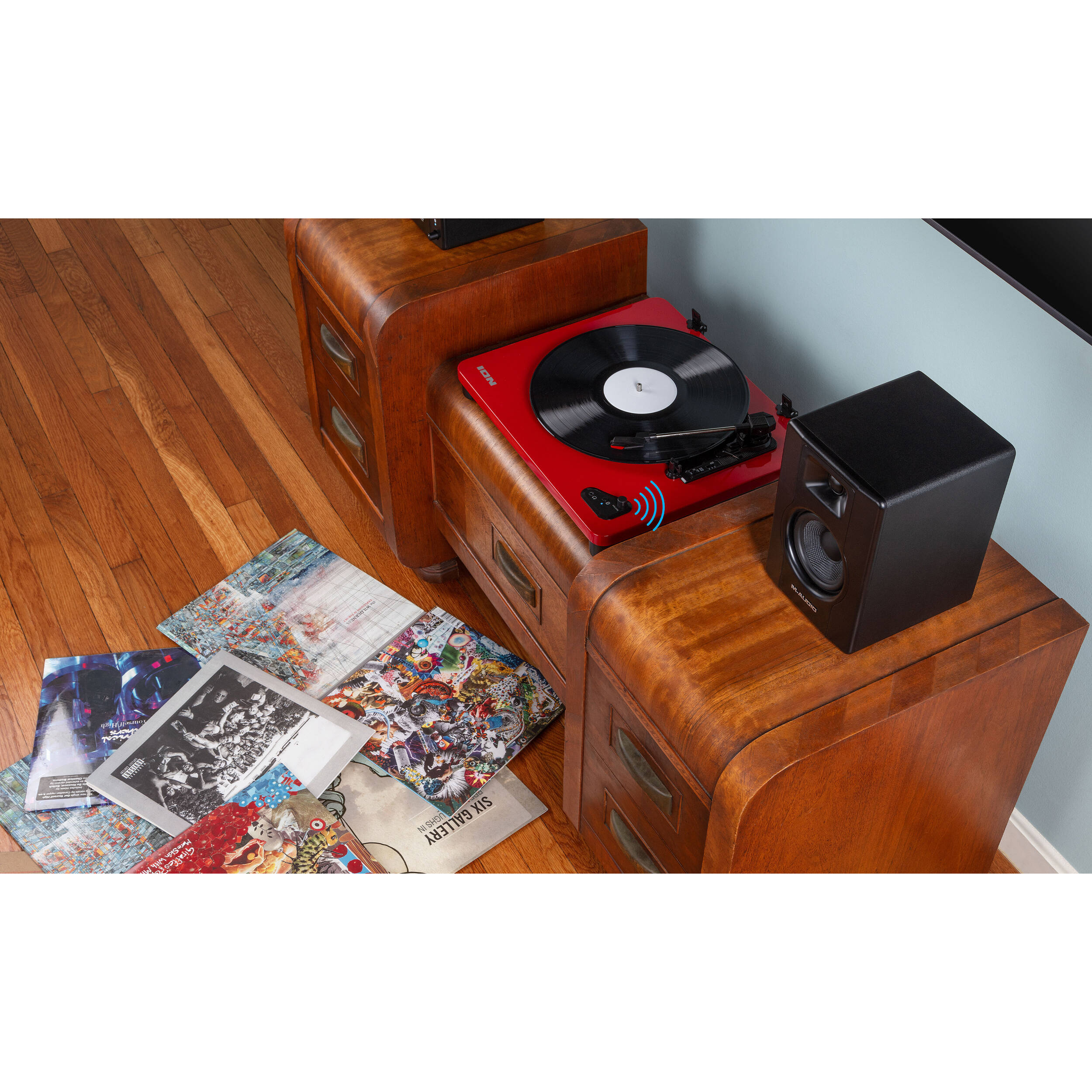 M-Audio BX3 BT desktop speakers shown on a desk with cables and controls visible. Compact audio speakers for desktop use.