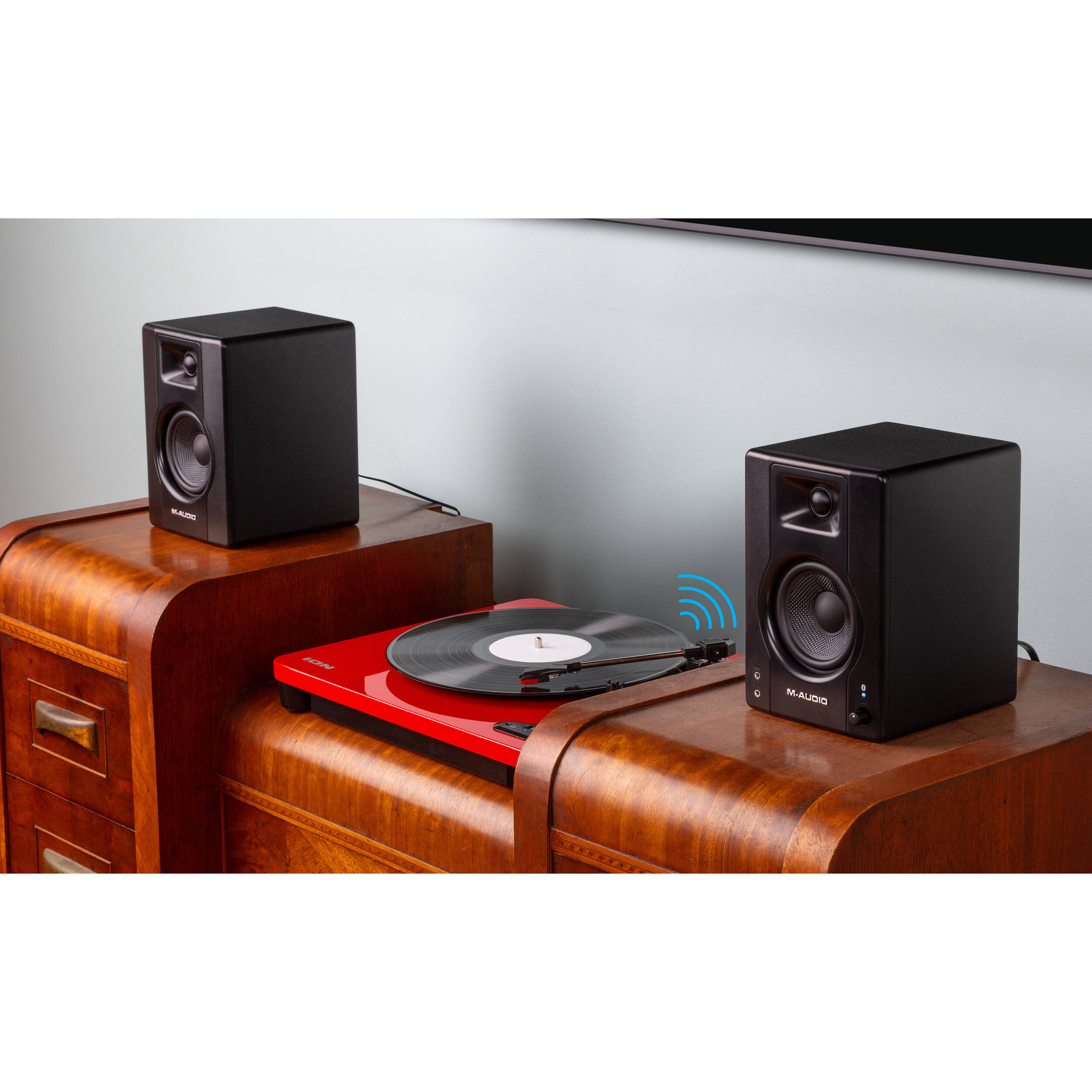M-Audio BX4 BT desktop speakers with black enclosures, compact design, and audio input ports visible on the front.