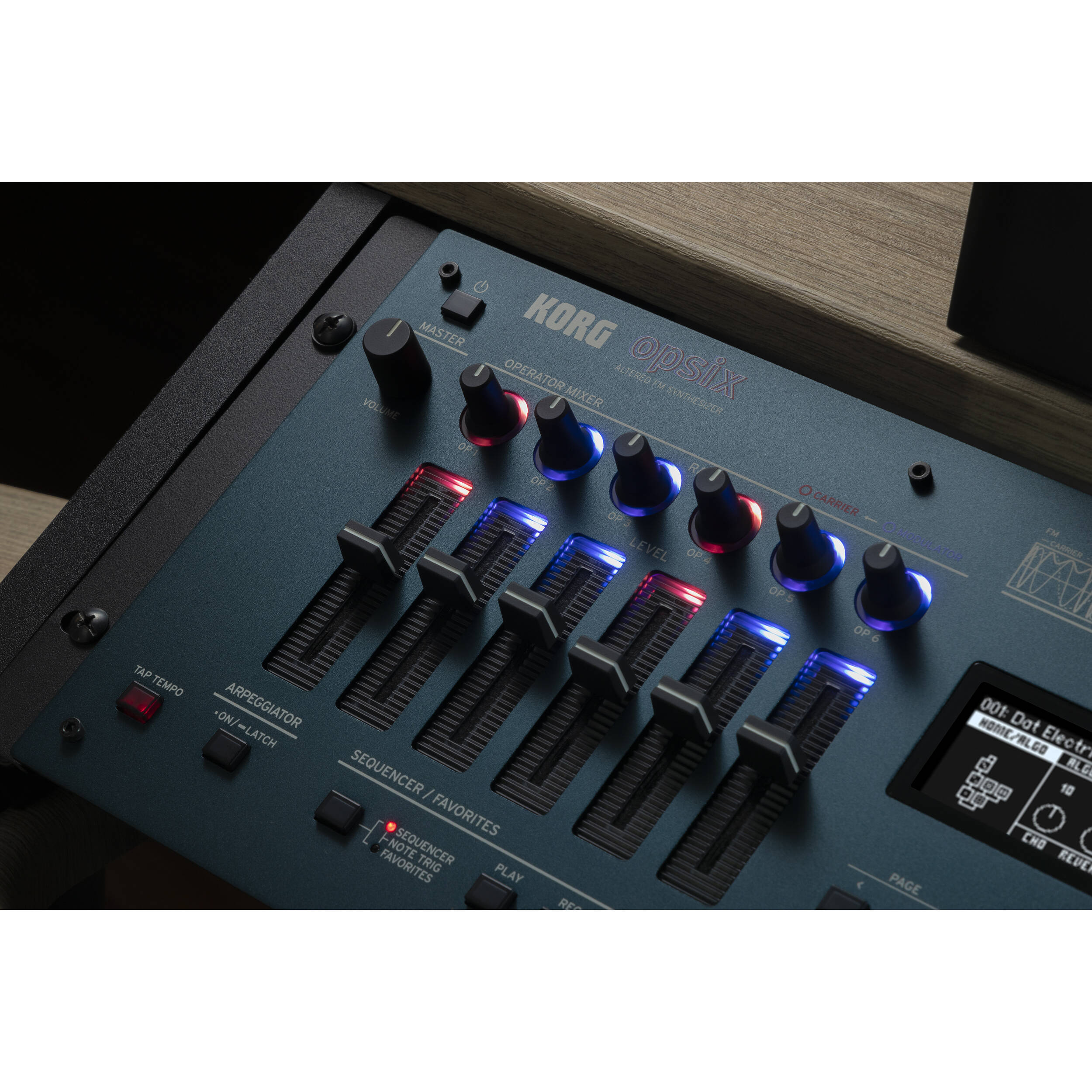 Korg Opsix synthesizer module with colorful control knobs and keyboard interface, showcasing compact electronic music equipment.