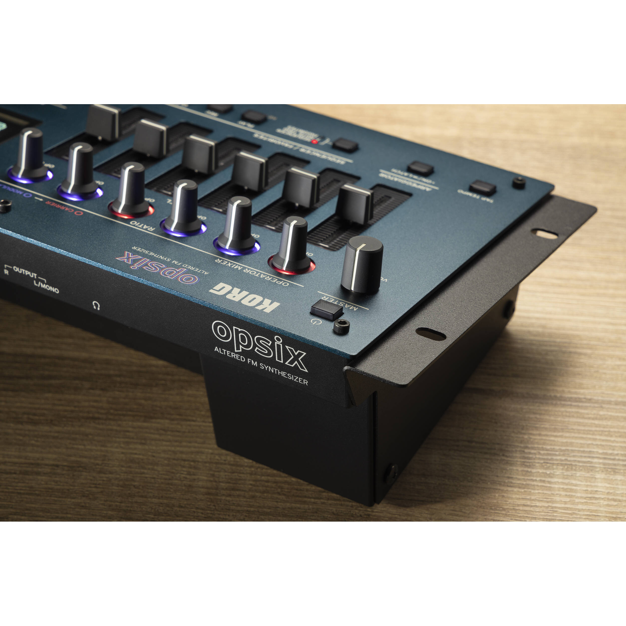 Korg Opsix synthesizer module with colorful control knobs and buttons, compact design, used for electronic music production.