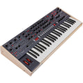 Sequential Trigon-6 synthesizer with a sleek black control panel and multiple knobs and buttons for sound modulation.