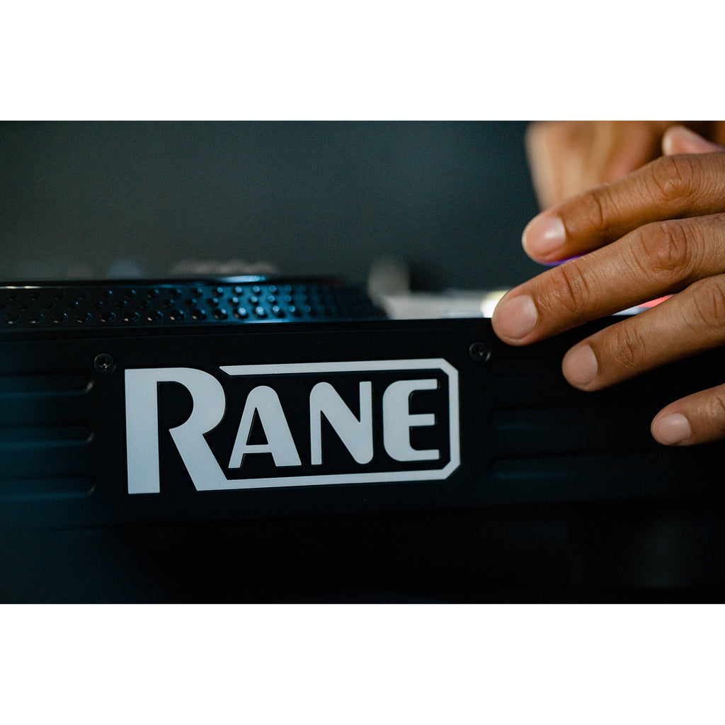 Rane Four DJ controller with two jog wheels, colorful LED pads, and control knobs for professional DJ mixing.