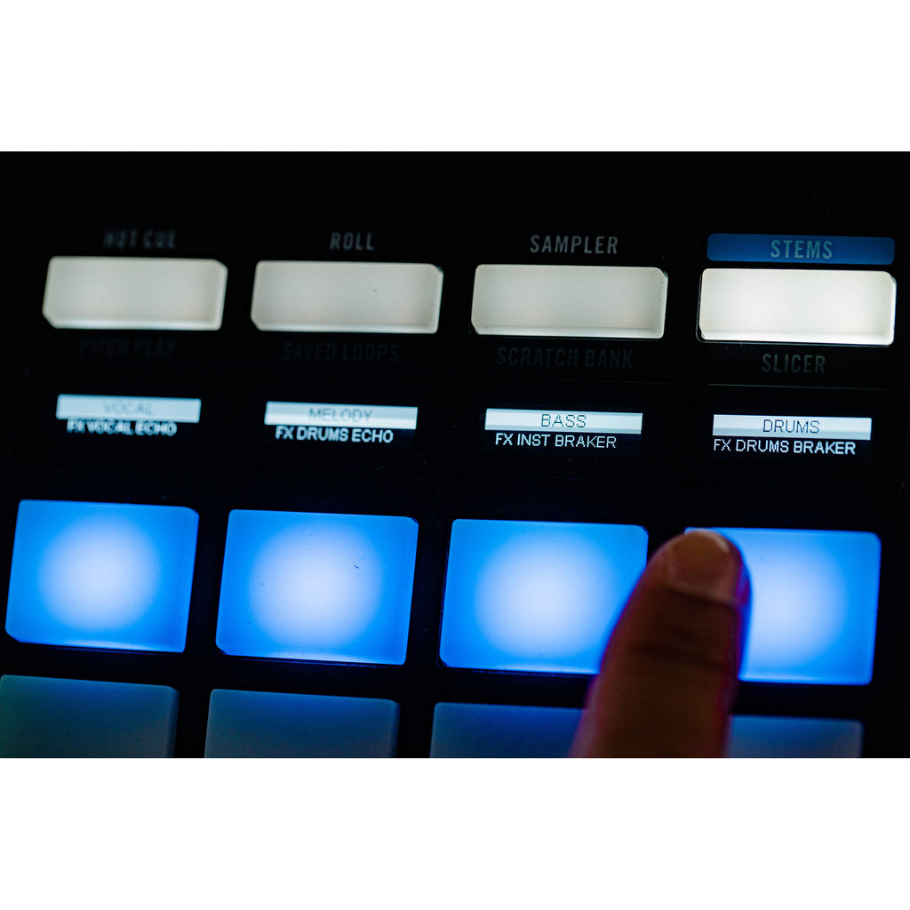 Rane Four DJ controller with dual jog wheels, mixer knobs, and colorful pads for professional DJ performance.