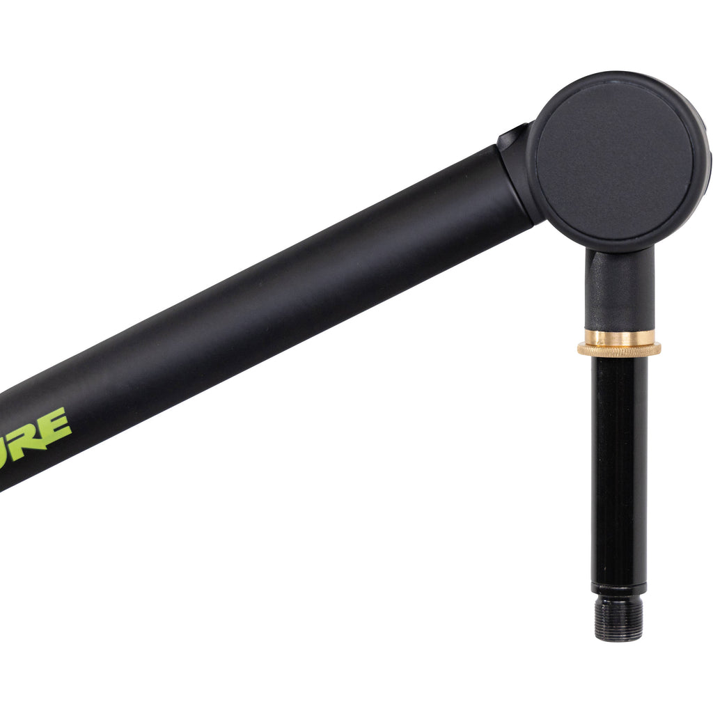 Shure SH-BROADCAST1 broadcast microphone arm mounted on a desk with adjustable arms and cable management for professional audio setups.
