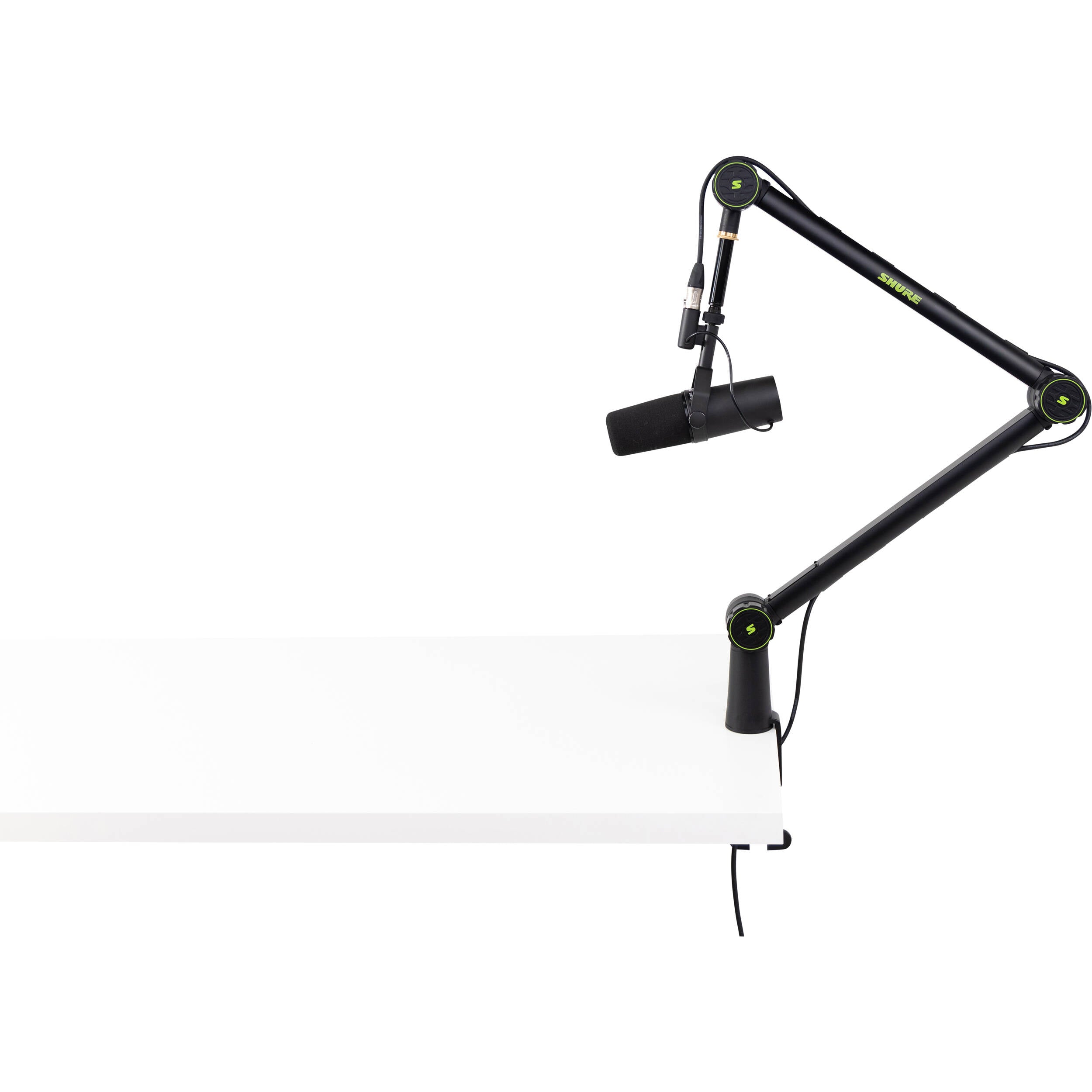 Shure SH-BROADCAST1 broadcast microphone arm mounted on a desk, adjustable arm with sleek black finish for professional audio setups.