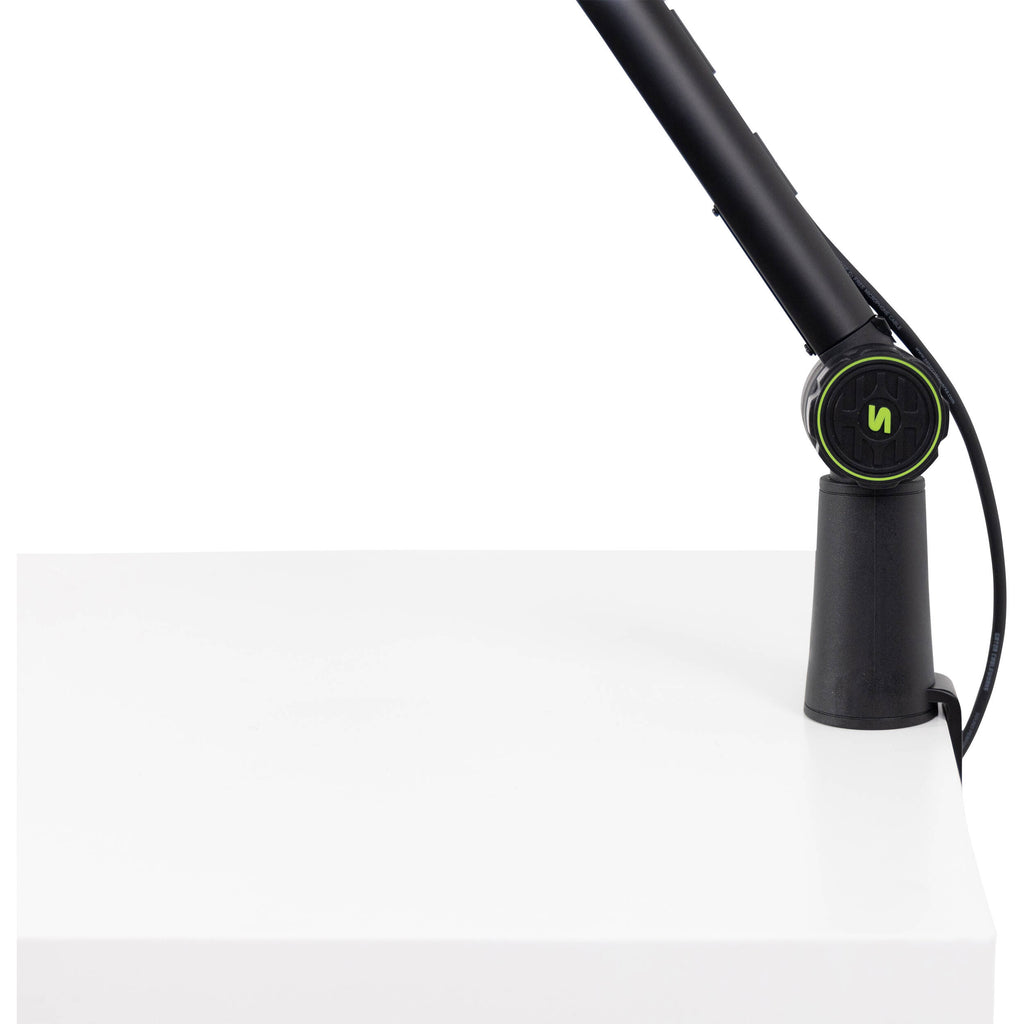 Shure SH-BROADCAST1 broadcast microphone arm mounted on a desk with microphone attached for professional audio recording setup