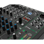 Mackie ProFX10v3+ analog mixer with multiple input channels, knobs, and audio output jacks, used for live sound and recording.