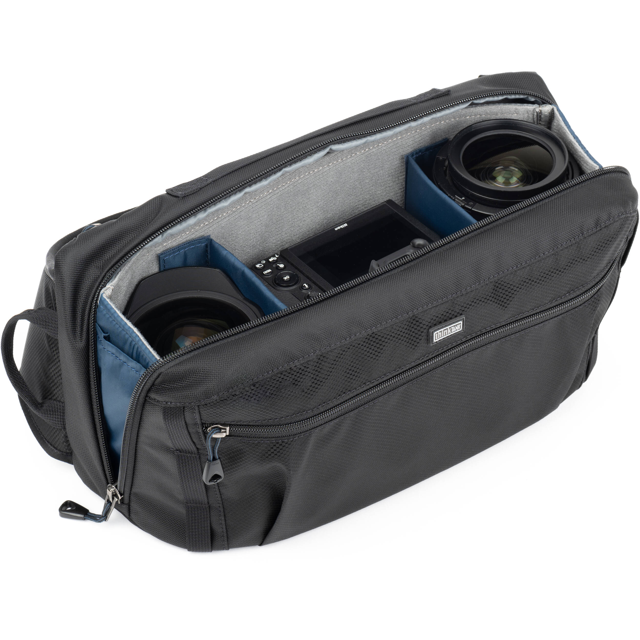 Think Tank PressPass sling bag for video equipment, compact design with multiple compartments for DSLR cameras and accessories.