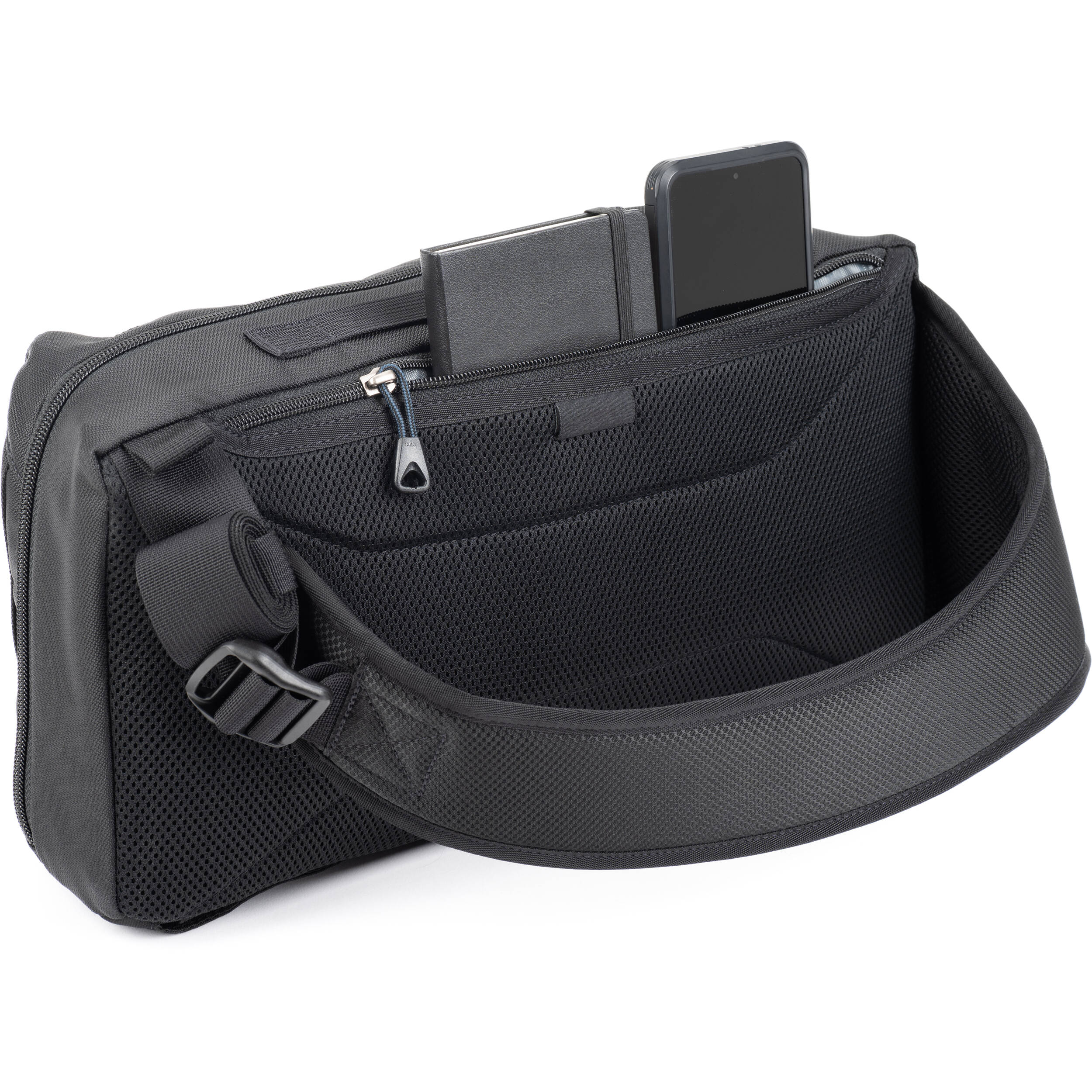 Think Tank PressPass Sling Bag for video equipment, black nylon with adjustable strap and multiple compartments.