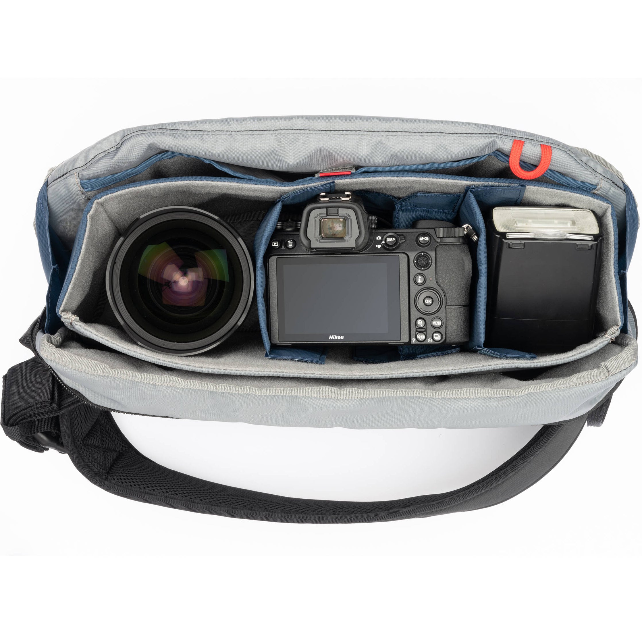 Think Tank PressPass Sling Bag for video equipment with padded compartments and adjustable strap for easy carrying.