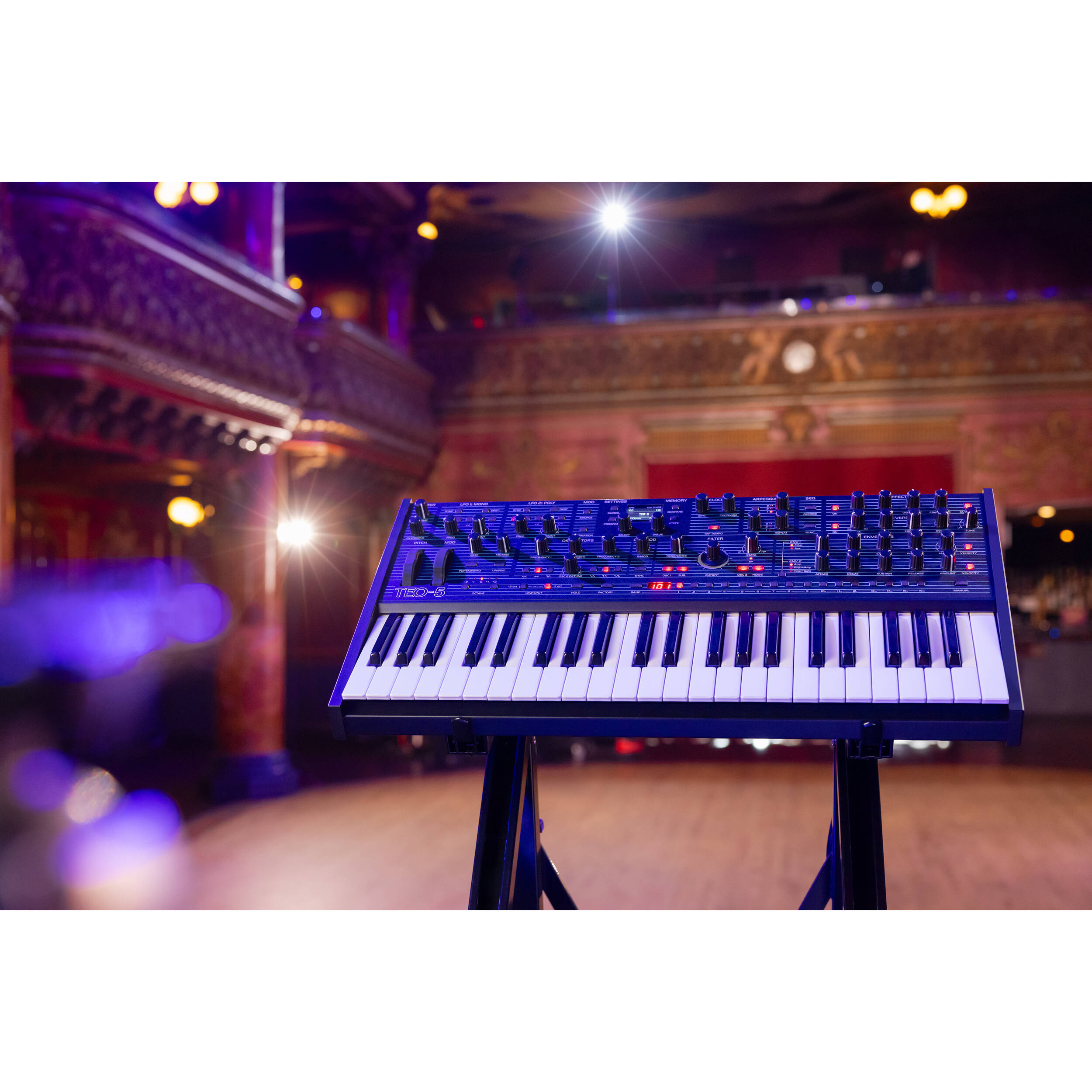 Oberheim TEO-5 synthesizer with vintage design, featuring multiple knobs and switches for sound modulation.