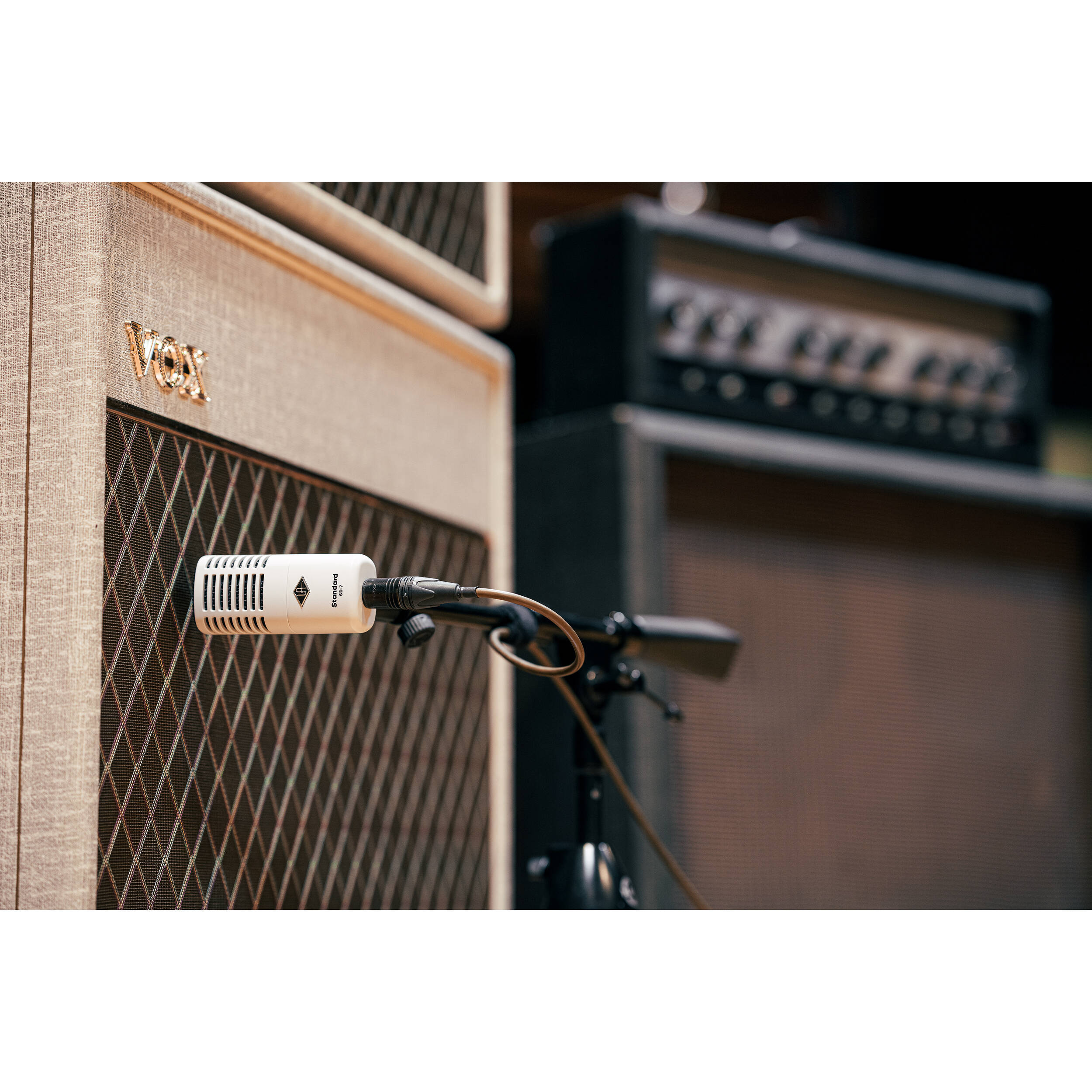 Universal Audio SD-7 dynamic microphone shown with its sleek design and grille, ideal for professional audio recording and live sound.