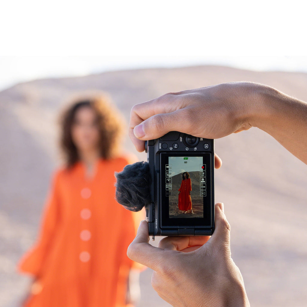 Sony ZV-E10 II mirrorless camera with 16-50mm zoom lens, showing the compact video camera with lens attached and camera controls.