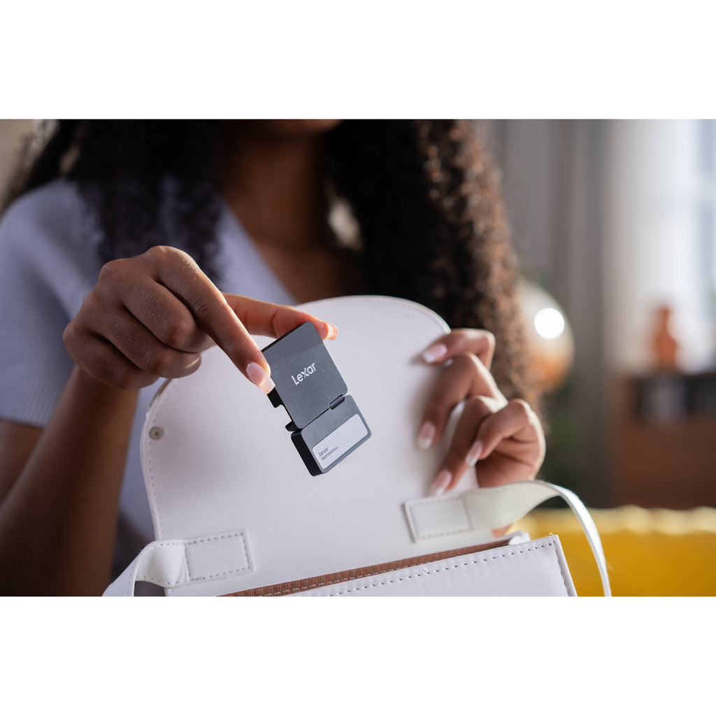Lexar Go Portable SSD external drive with hub, sleek black design, connected to a computer for fast data transfer and storage.