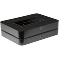 Bluesound Powernode 2025 music streamer with sleek black design and front panel controls, connected to audio equipment.
