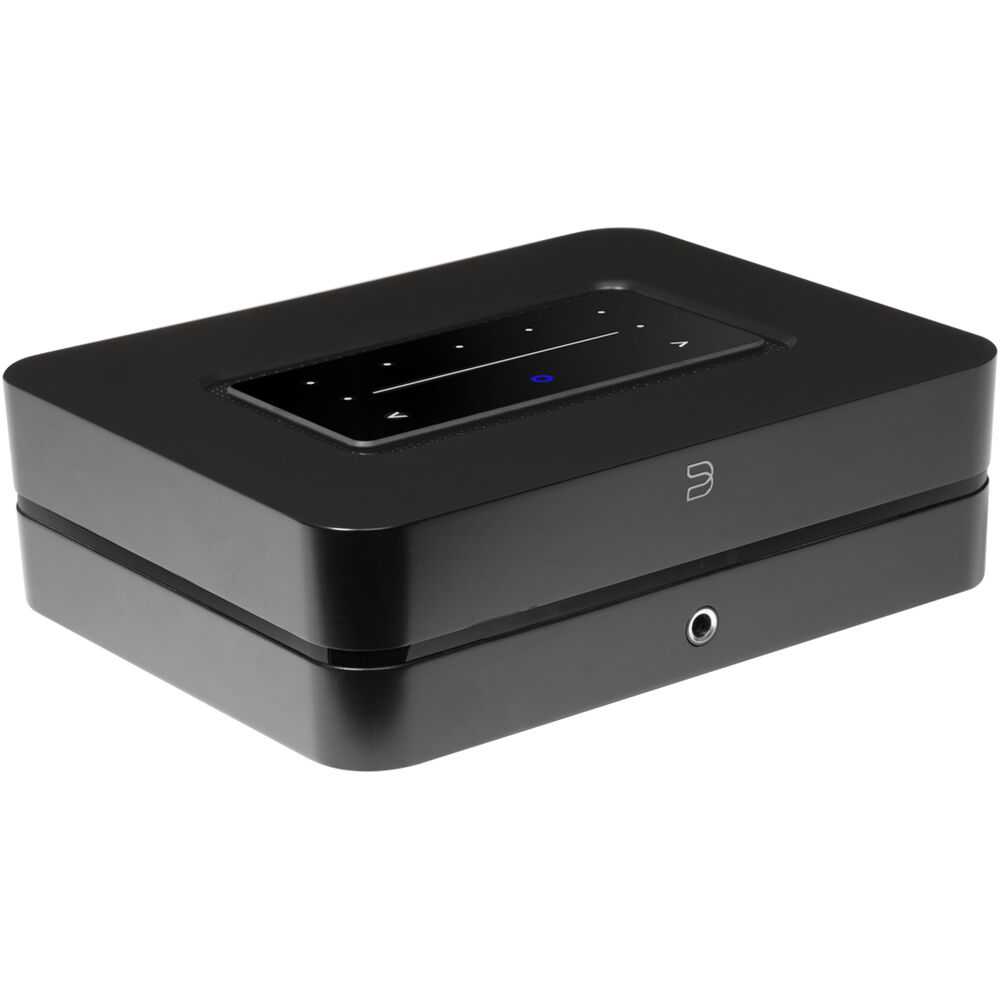Bluesound Powernode 2025 music streamer with sleek black design and front panel controls, connected to audio equipment.