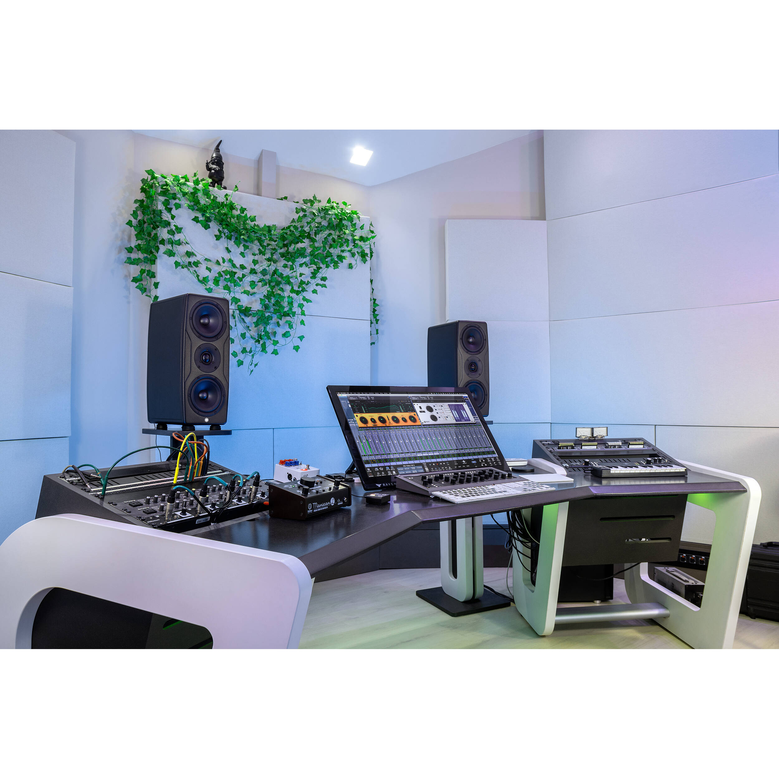 IK Multimedia iLoud Precision MTM MK2 active nearfield monitors showing the sleek black design and control panel.