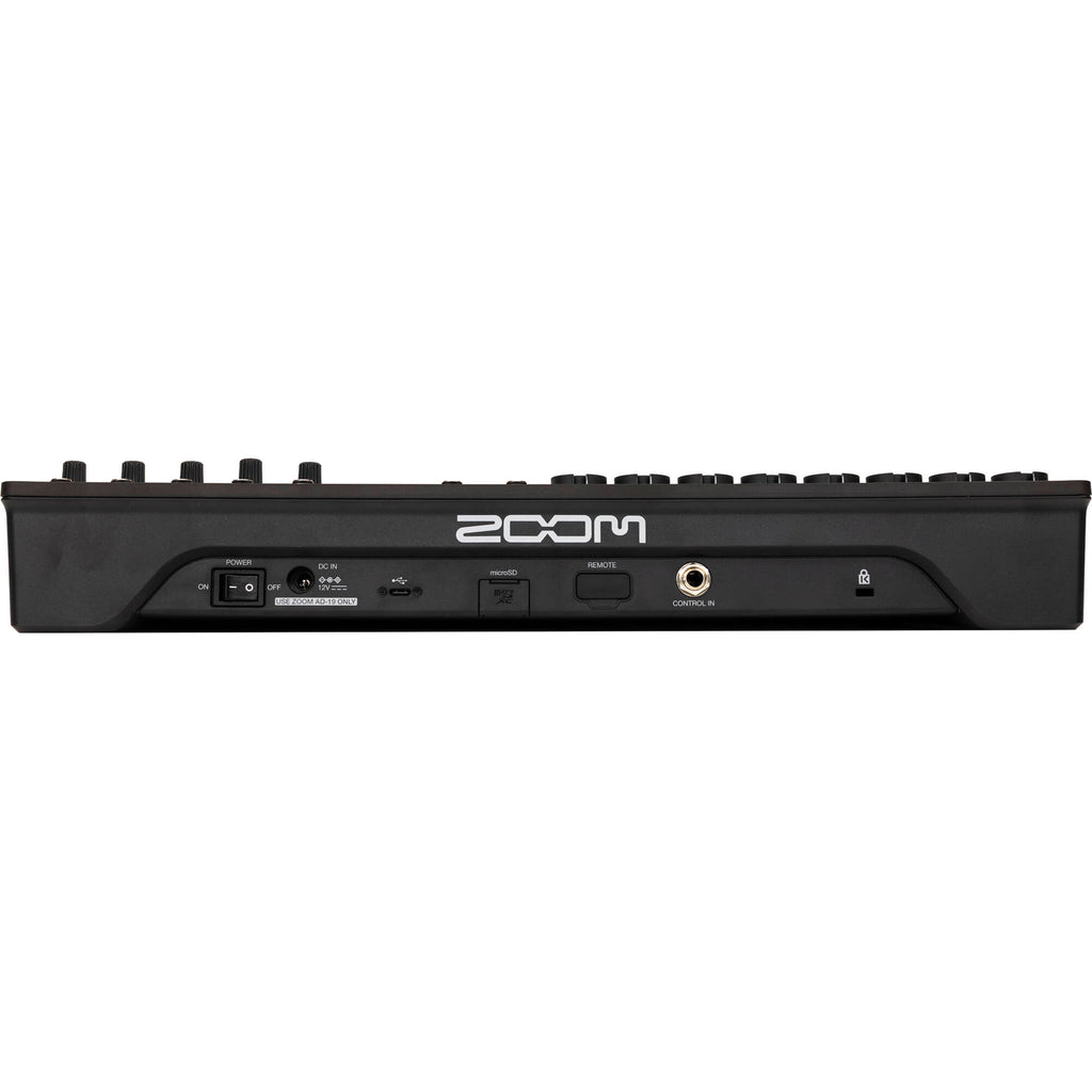 Zoom LiveTrak L12next digital mixer with multiple input channels and control knobs, shown on a table with cables.
