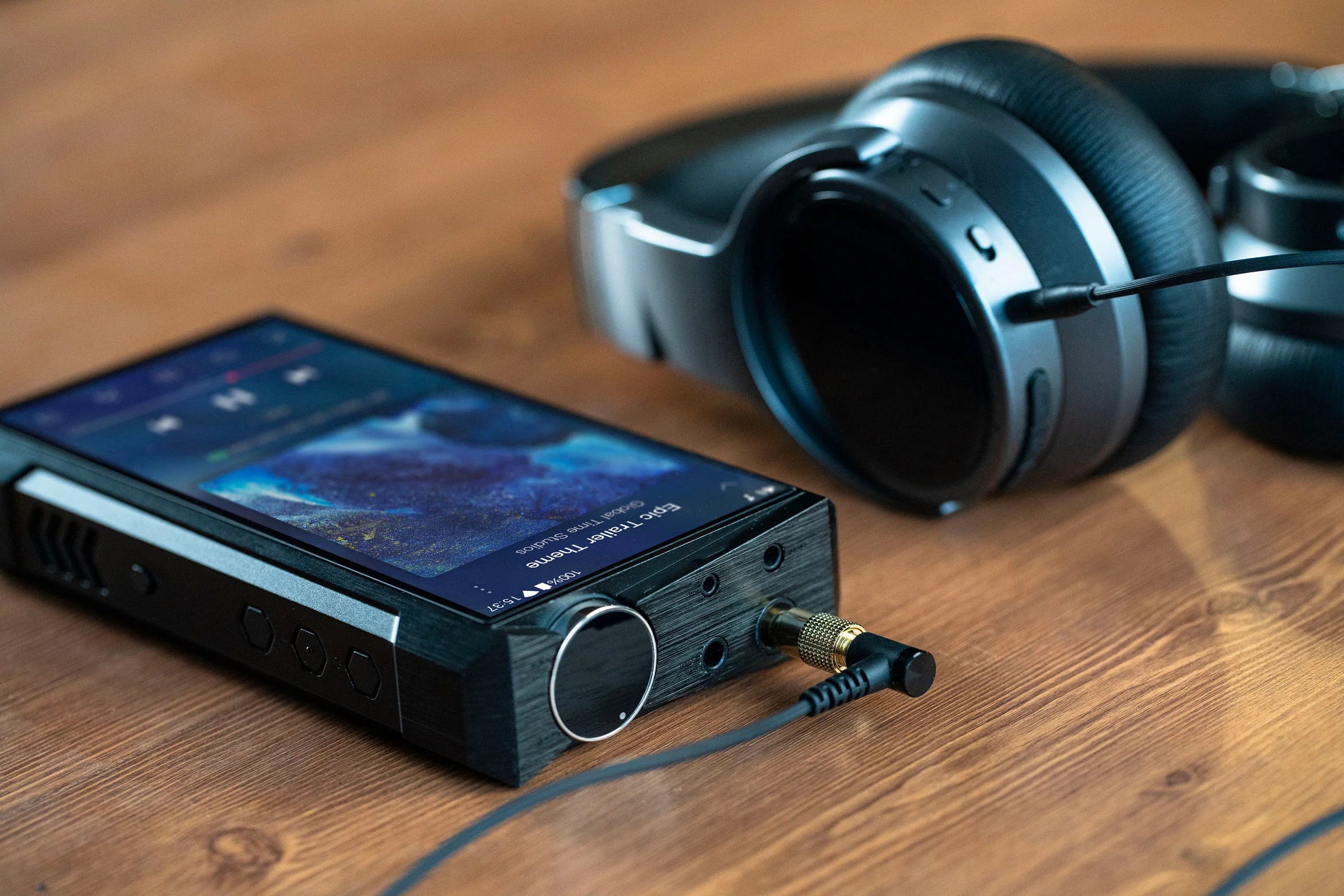 FiiO M17 portable music player with large touchscreen display, multiple control buttons, and sleek black design.