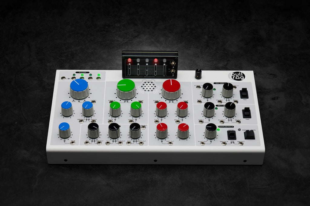 Erica Synths Bullfrog desktop synthesizer with knobs, buttons, and patch points on a black panel with colorful accents.