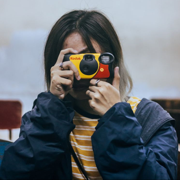Kodak FunSaver 27+12 disposable camera for instant photos, compact and lightweight with a built-in flash.