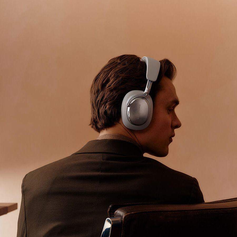 Bowers & Wilkins Px8 S2 wireless headphones with sleek black design and padded ear cups, shown from a side angle.