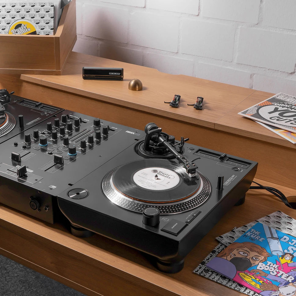 Black Reloop RP-7 DJ turntable with sturdy build, tonearm, and control knobs, ideal for professional DJ setups.