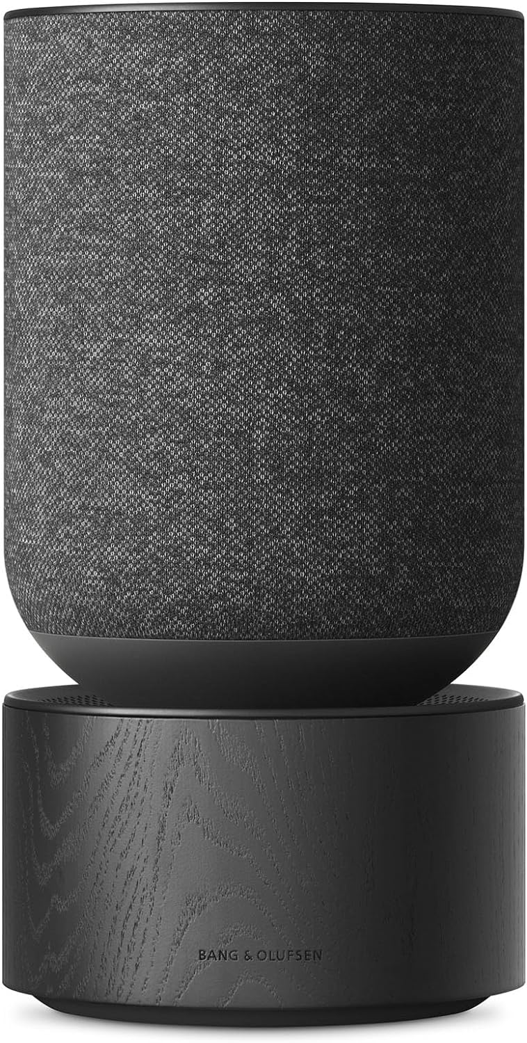 Bang & Olufsen Beosound Balance wireless speaker with sleek design and premium wood finish, featuring touch controls and fabric grille.