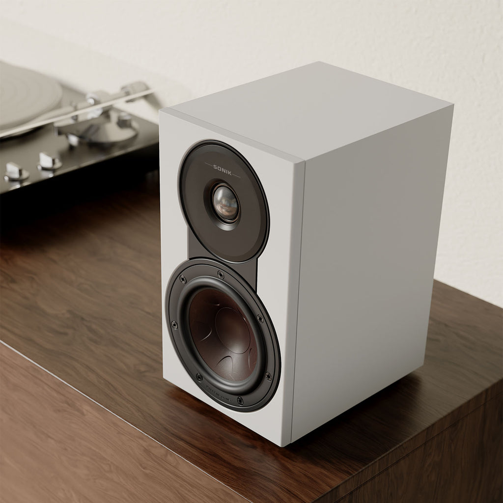 DALI Sonik 1 passive bookshelf speakers with black wood finish and compact design, showing the front grille and speaker drivers.