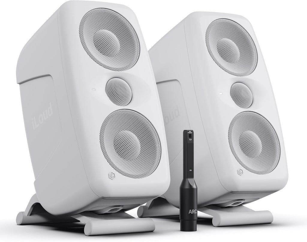 IK Multimedia iLoud MTM MK2 active nearfield monitors sitting on a desk, with their sleek black design and front speaker grilles.