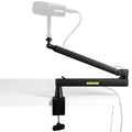 Shure SH-BROADCAST2 broadcast microphone arms mounted on a desk with adjustable arms and microphone attachment for professional broadcasting.