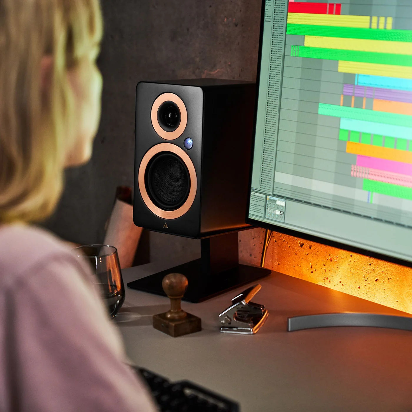Argon Audio Forte A5 WiFi active bookshelf speakers on a wooden stand, showcasing the sleek black design and front speaker grille.