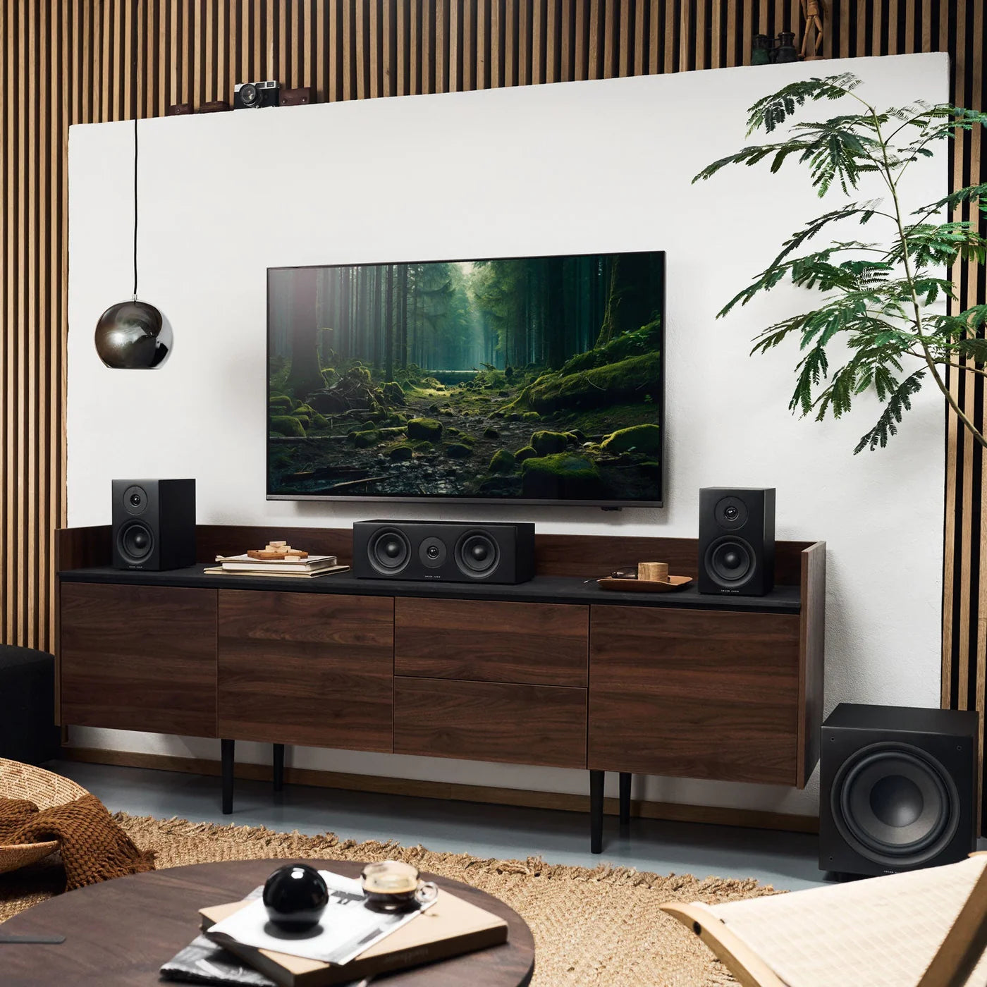 Argon Audio Forus 4 passive bookshelf speakers in black with sleek design and wood finish accents, shown from front angle.