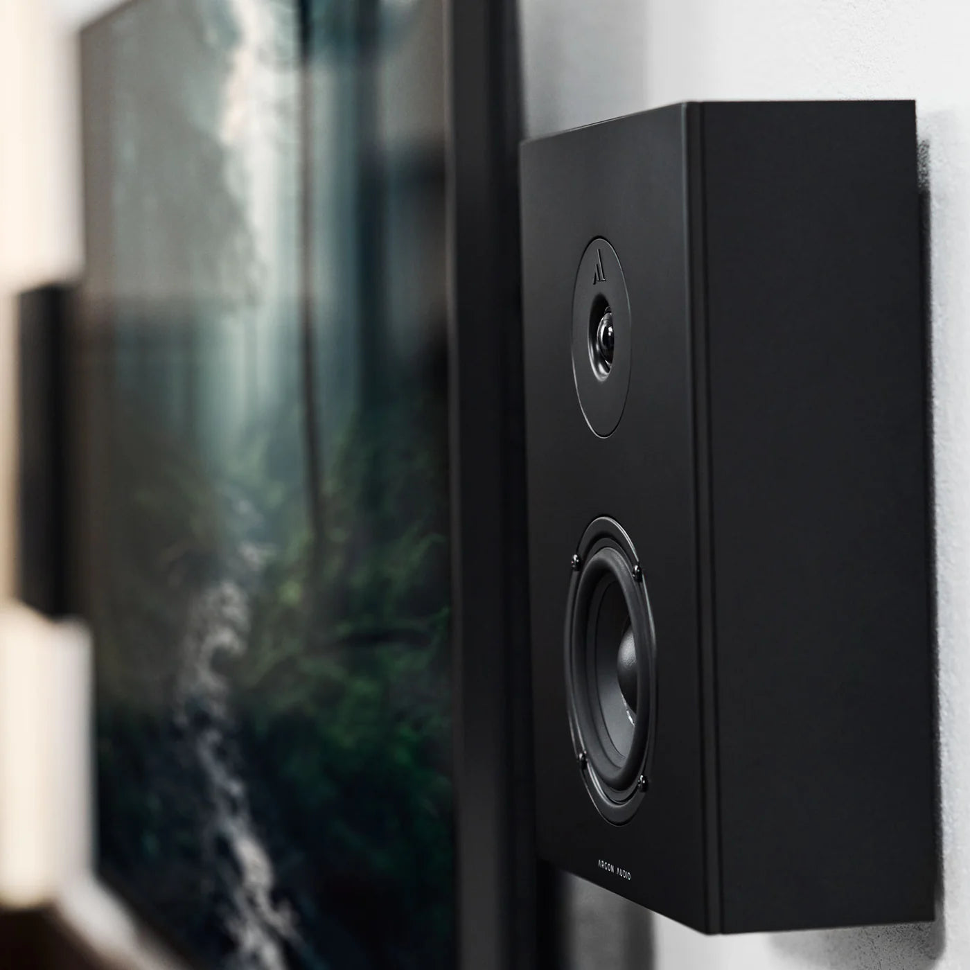 Black Argon Audio Forus 4 In-Wall and Outdoor Speakers installed on a wall, showcasing sleek design and outdoor audio performance.
