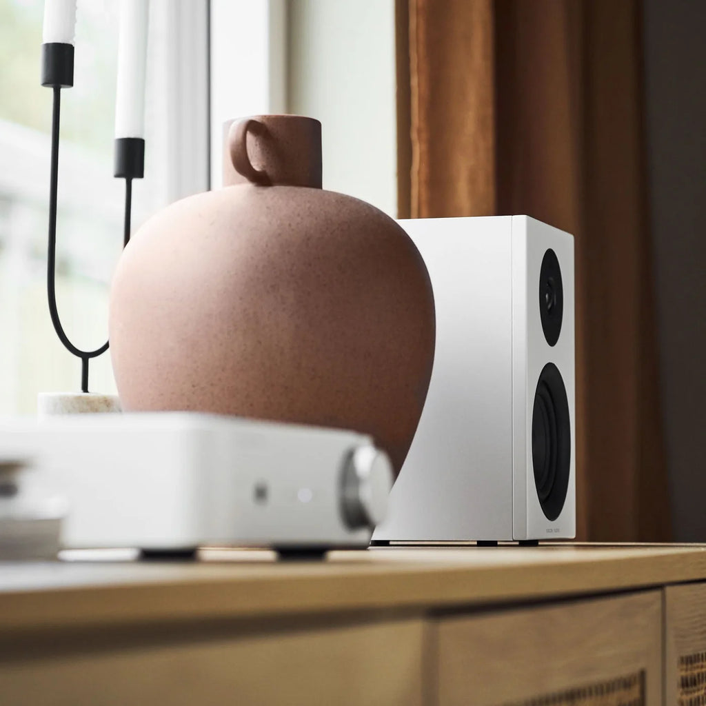 White Argon Audio Forus 4 passive bookshelf speakers shown from the side with a sleek design and compact size.